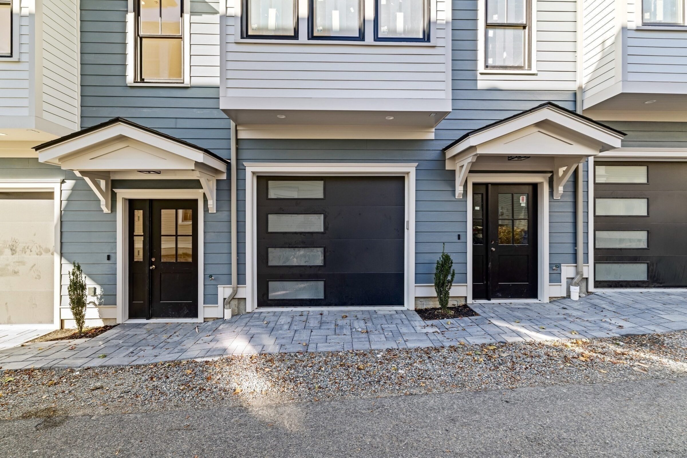 Front entrance and garage doors along the row of townhomes.