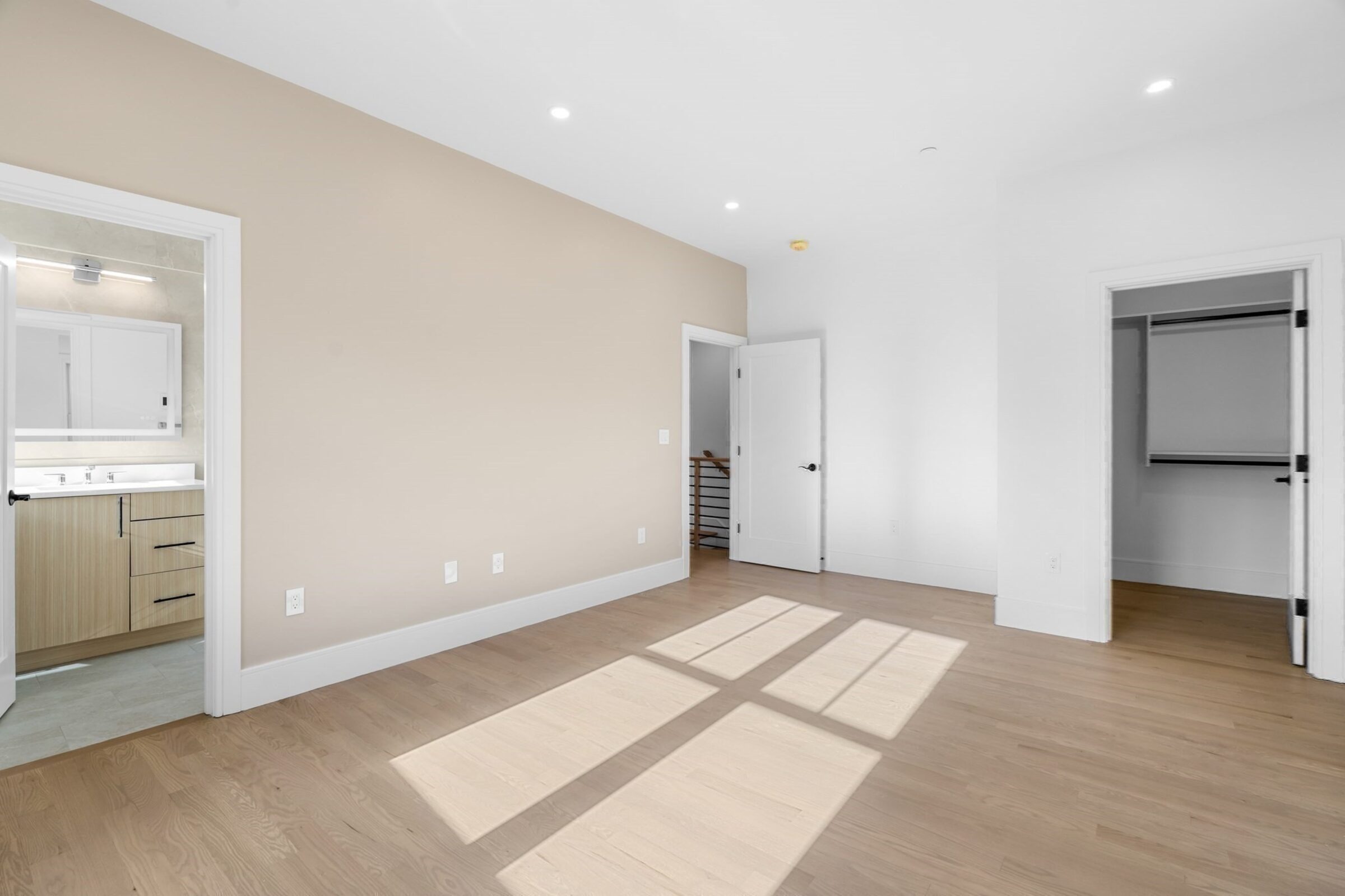 Sun-filled open living space with wide-plank oak flooring.